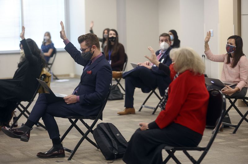 Members of the public who want to speak in opposition to HB302 raise their hands during a House Education Committee meeting at the State Office Building in Salt Lake City on Thursday,
Feb. 11, 2021. The bill would bar transgender athletes at public
schools to participate in girls sports.