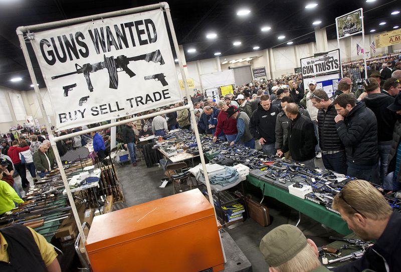 Crowds gather around used weapons dealers at the South
Towne Expo Center during the 2013 Rocky Mountain Gun Show on
Saturday, Jan. 5, 2013.