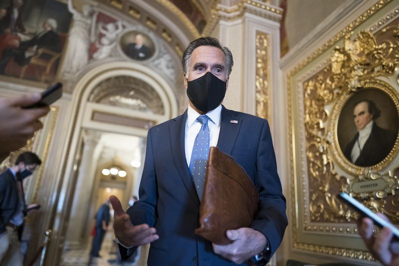 Sen. Mitt Romney, R-Utah, pauses to answer questions from reporters at the Capitol in Washington, Tuesday, Feb. 23, 2021.