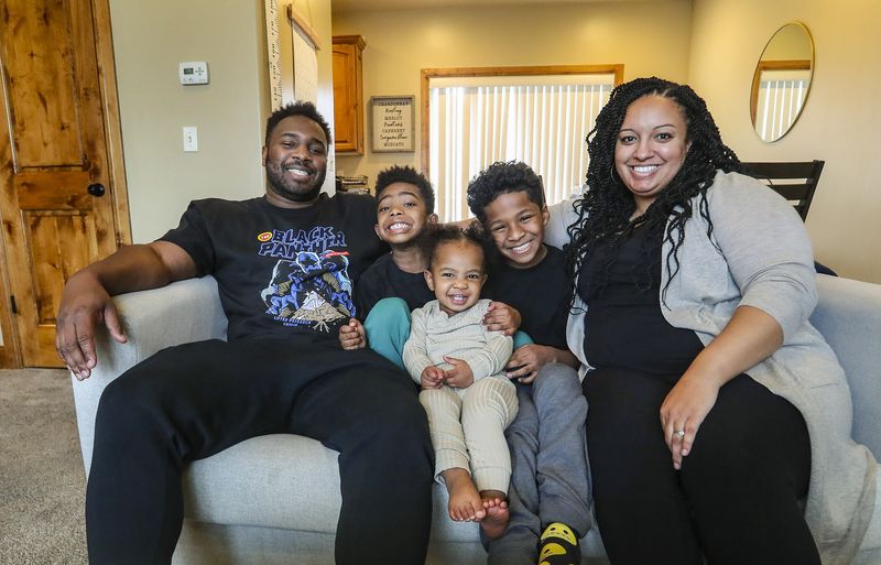 The Rowes — Julius, left, his wife, Danielle, right,
and their children Julius Jr., Laila and Malik, pose for a photo in
their home in Murray on Wednesday, Feb. 24, 2021.