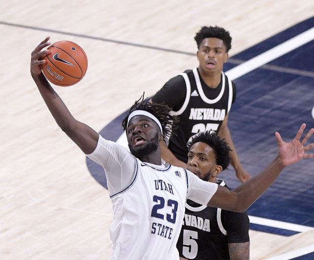 Neemias Queta pulls down a rebound against Nevada, Sunday, Feb. 28, 2021 in Logan.