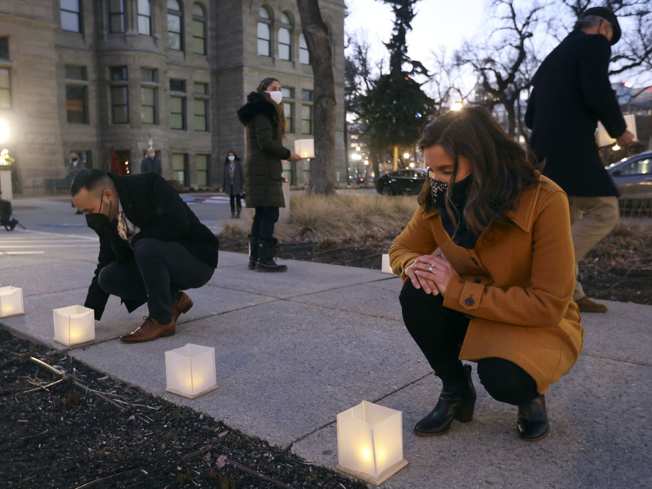 Salt Lake City Councilman Darin Mano and Salt Lake
City Mayor Erin Mendenhall place lanterns in a tribute to
the city’s victims and survivors of COVID-19 outside of the
City-County Building in Salt Lake City on Monday, March 1, 2021.