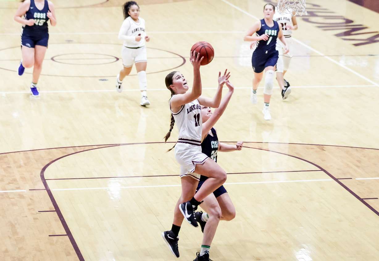 Lone Peak's Kailey Woolston drives against Syracuse's Rachel Godfrey in a 6A girls basketball quarterfinal game in Highland on Tuesday, March 2, 2021.