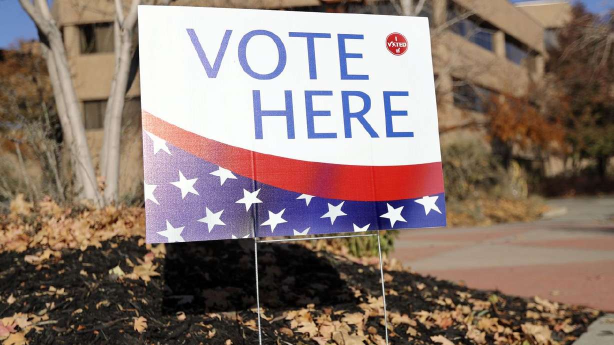 A "Vote Here” sign is pictured on Election Day at the
Salt Lake County Government Center in Salt Lake City. A bill to cut
off Utahns’ ability to switch political party affiliation months
before primary elections has won approval from the
Legislature.
