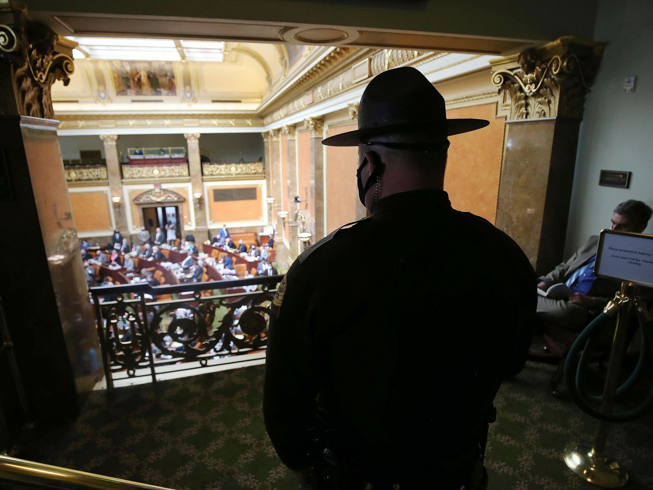 Utah Highway Patrol trooper Lance Christensen stands
inside the House gallery at the Capitol in Salt Lake City on
Wednesday, March 3, 2021, as the Legislature meets during its 2021
general session.