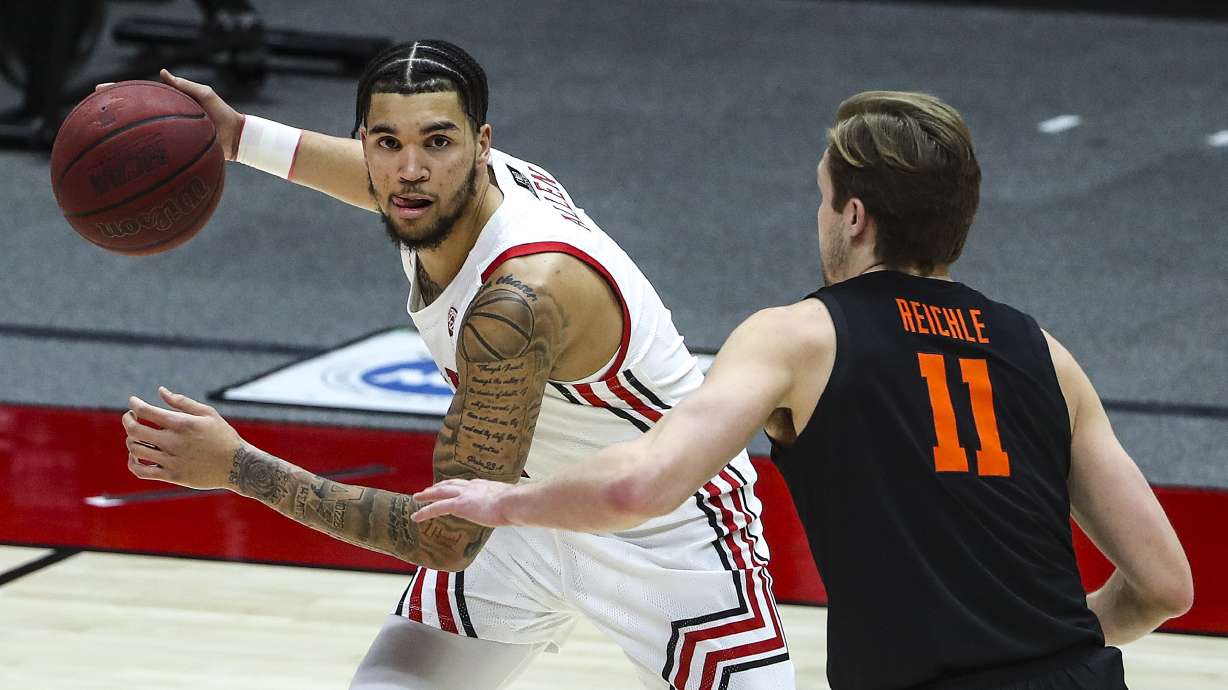 Utah Utes forward Timmy Allen (1) looks to pass the ball as he is guarded by Oregon State Beavers guard Zach Reichle (11) during a game at the Huntsman Center on the University of Utah campus in Salt Lake City on Wednesday, March 3, 2021.