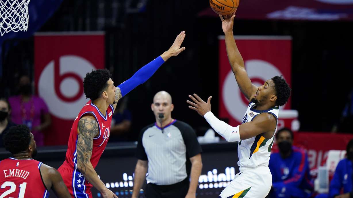 Utah Jazz's Donovan Mitchell, right, goes up for a shot against Philadelphia 76ers' Danny Green during the first half of an NBA basketball game, Wednesday, March 3, 2021, in Philadelphia. (AP Photo/Matt Slocum)