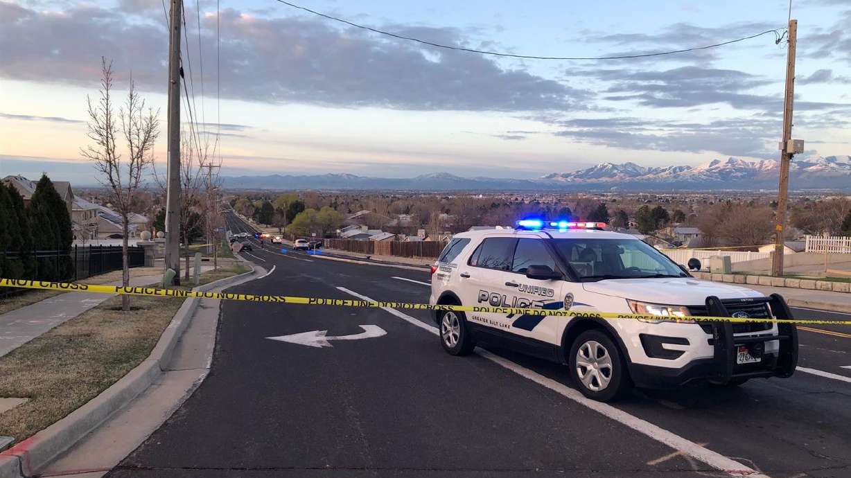 A police vehicle is pictured at the scene of a police
shooting in Taylorsville on March 21, 2020. On Friday, the Salt
Lake County District Attorney’s Office concluded that a Unified
police officer was not legally justified when he shot and killed an
unarmed man. But no criminal charges will be filed against the
officer.