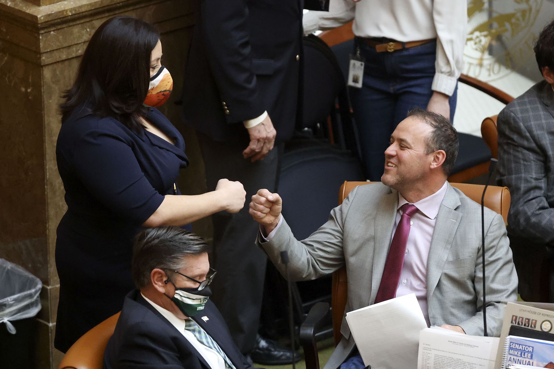 Rep. Angela Romero, D-Salt Lake City, left, fist-bumps Rep. Mike Schultz, R-Hooper, in the House chamber at the Capitol in Salt Lake City on Friday, March 5, 2021, the final day of the Utah Legislature’s 2021 general session.