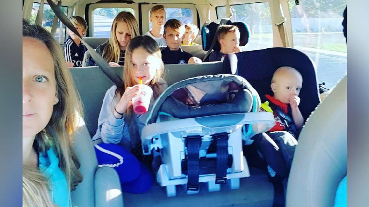 Arianne Brown's family of 11 sitting in their 12-passenger van on an early soccer Saturday (pre-COVID-19 pandemic).