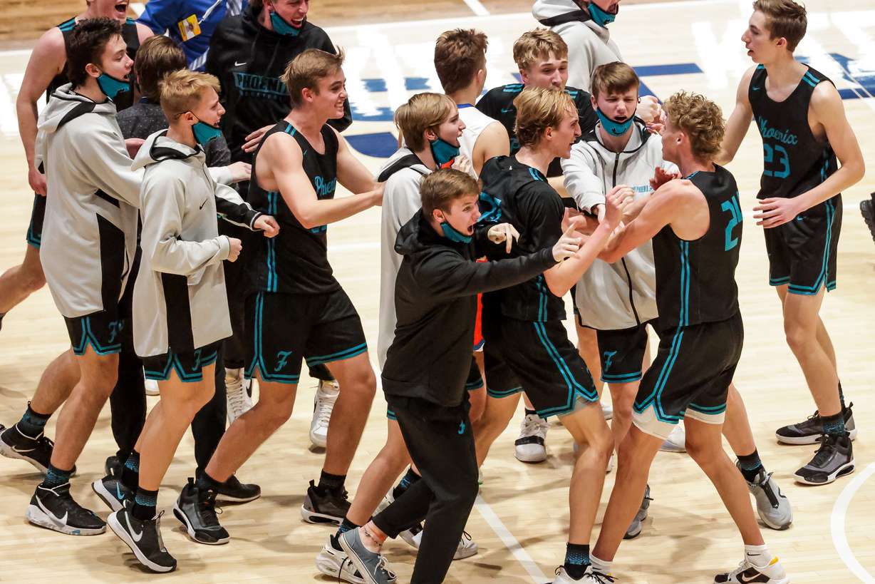 Farmington celebrates after beating Timpview in a 5A boys basketball semifinal game at Salt Lake Community College in Taylorsville on Friday, March 5, 2021.