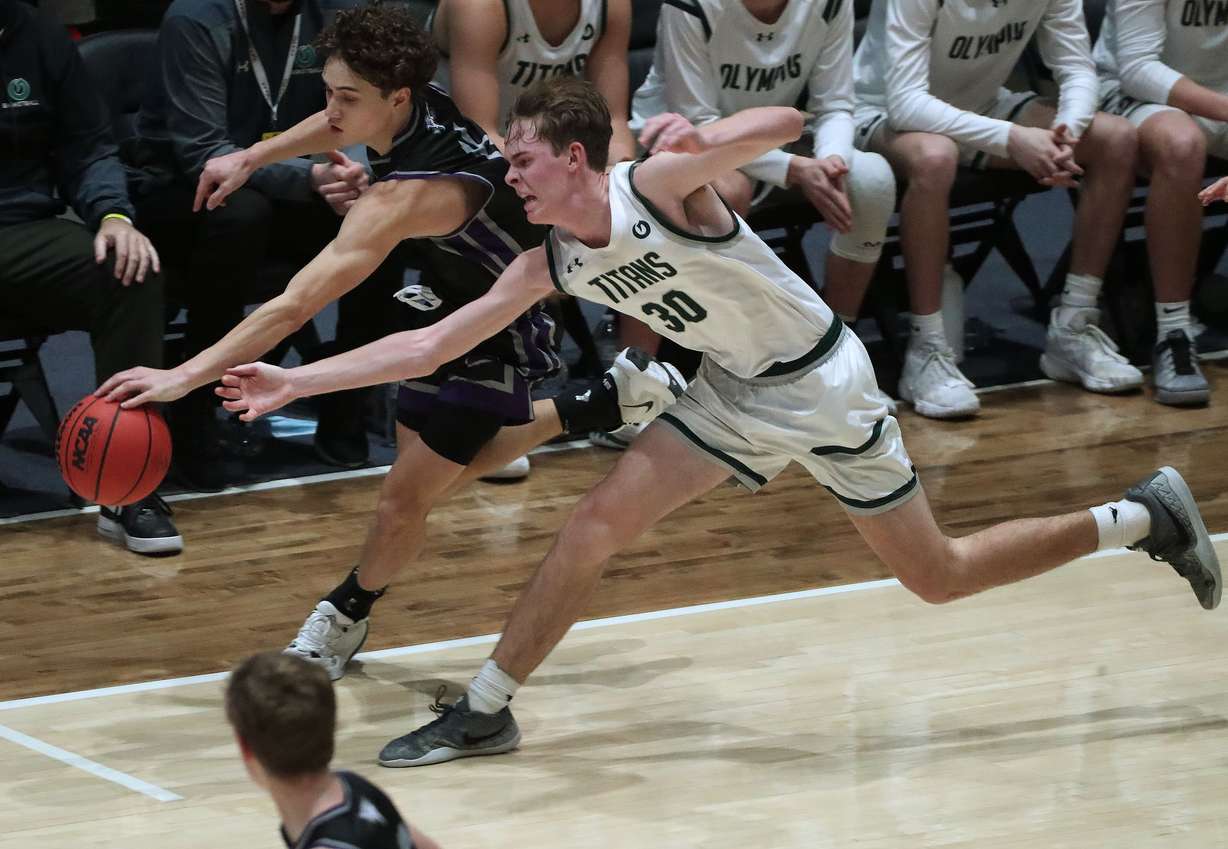 Lehi’s Noa Gonsalves and Olympus’ Dutch Dowdell compete for the ball during the 5A boys basketball semifinal game at Salt Lake Community College in Taylorsville on Friday, March 5, 2021. Lehi won 69-58.