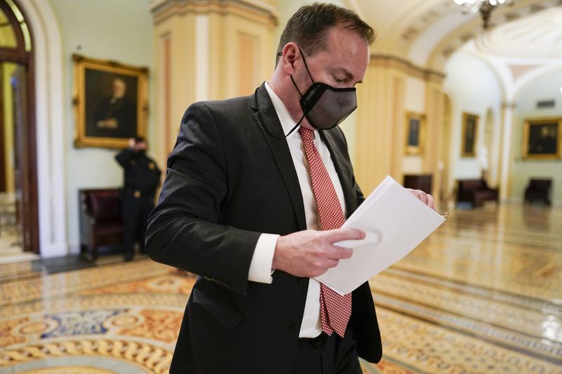 Sen. Mike Lee, R-Utah, walks on Capitol Hill as the
Senate works to complete the Democrats’ $1.9 trillion COVID-19
relief bill, in Washington on Saturday, March 6, 2021.