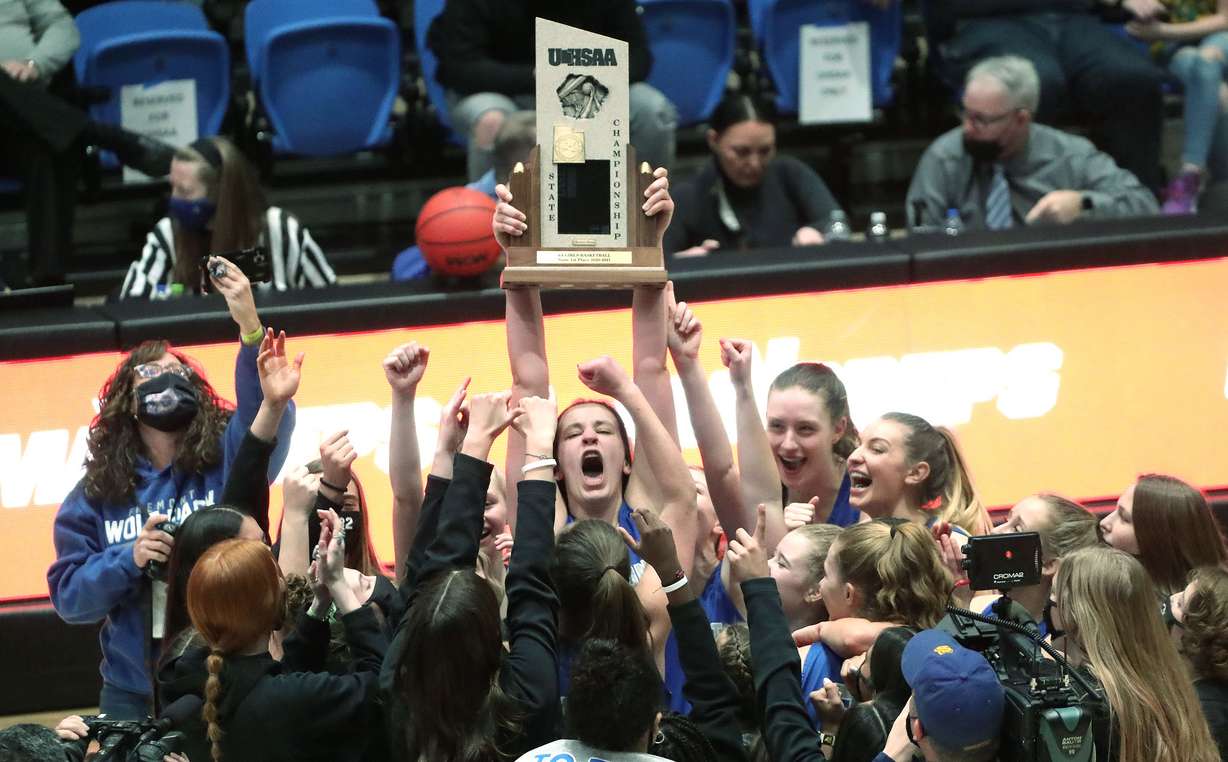 Fremont's Emma Calvert (25) and teammates hoist the trophy as they celebrate their win over Herriman during the 6A girls basketball championship game at Salt Lake Community College in Taylorsville on Saturday, March 6, 2021. Fremont won 63-43.