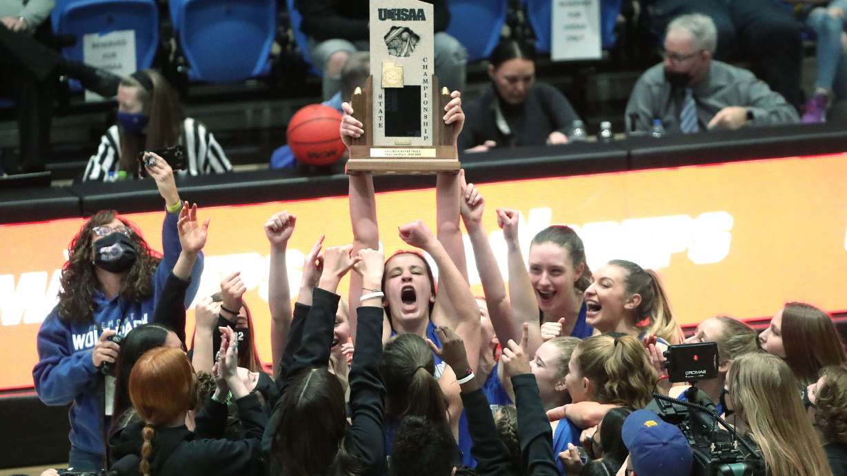 Fremont's Emma Calvert (25) and teammates hoist the trophy as they celebrate their win over Herriman during the 6A girls basketball championship game at Salt Lake Community College in Taylorsville on Saturday, March 6, 2021. Fremont won 63-43.