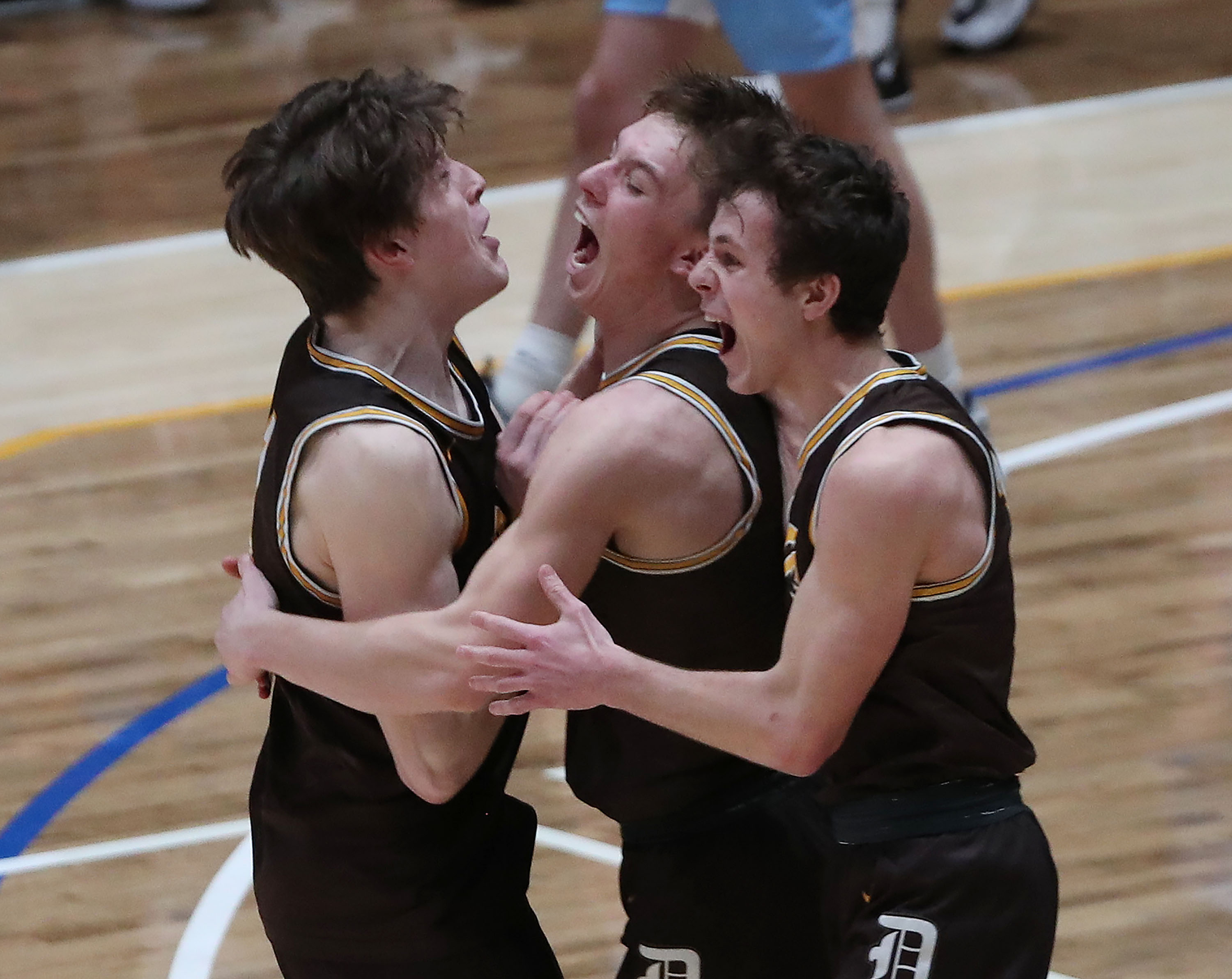 Davis' Rex Sunderland, Chance Trujillo and Colby Sims celebrate their win over West Lake during the 6A boys basketball championship game at Salt Lake Community College in Taylorsville on Saturday, March 6, 2021. Davis won 60-55.