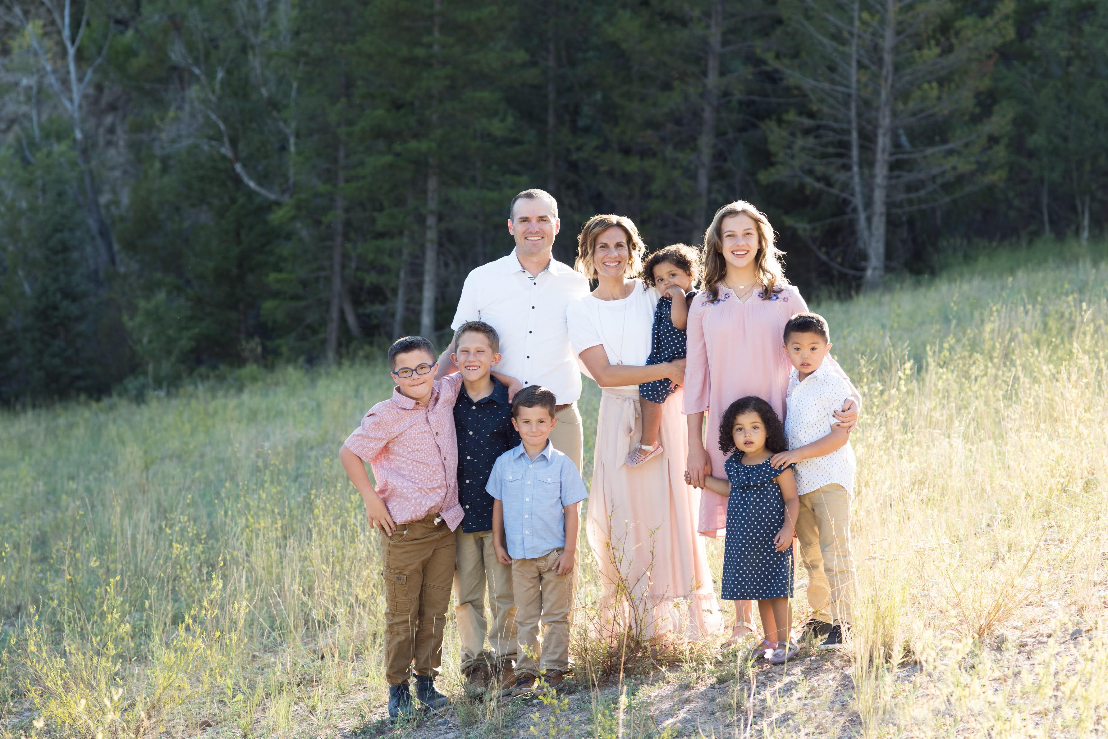 Bryce and Andrea Murray pose with their six children including sons Nash and Cooper who have Down Syndrome.