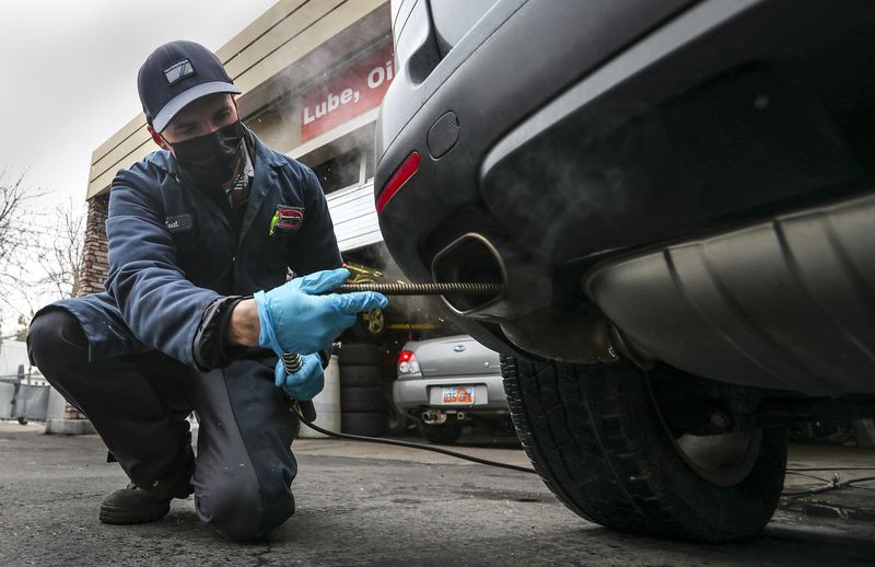 Teal Buchi performs an emission test on a vehicle at
Craig’s Service Center in Salt Lake City on Tuesday, Jan. 26,
2021.