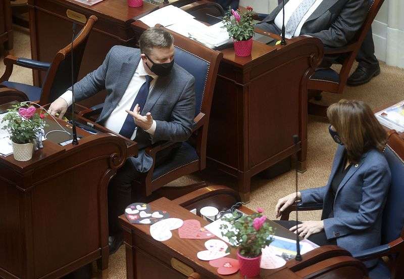 Sen. Todd Weiler, R-Woods Cross, left, talks to Sen.
Kathleen Riebe, D-Cottonwood Heights, in the Senate chamber after
Weiler proposed amendments to SB107 at the Capitol in Salt Lake
City on Friday, Feb. 12, 2021. The language in Weiler’s bill
originally took aim at the Salt Lake City School District as the
only district that had not offered an in-person learning option at
the time. The language now focuses on requirements surrounding
"test to stay” protocols and thresholds.