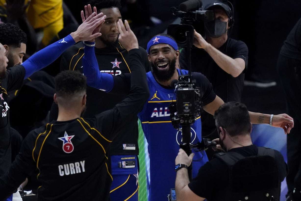 Golden State Warriors guard Stephen Curry and Utah Jazz guard Mike Conley celebrate during the first half of basketball's NBA All-Star Game in Atlanta, Sunday, March 7, 2021. (Photo: Brynn Anderson, Associated Press)