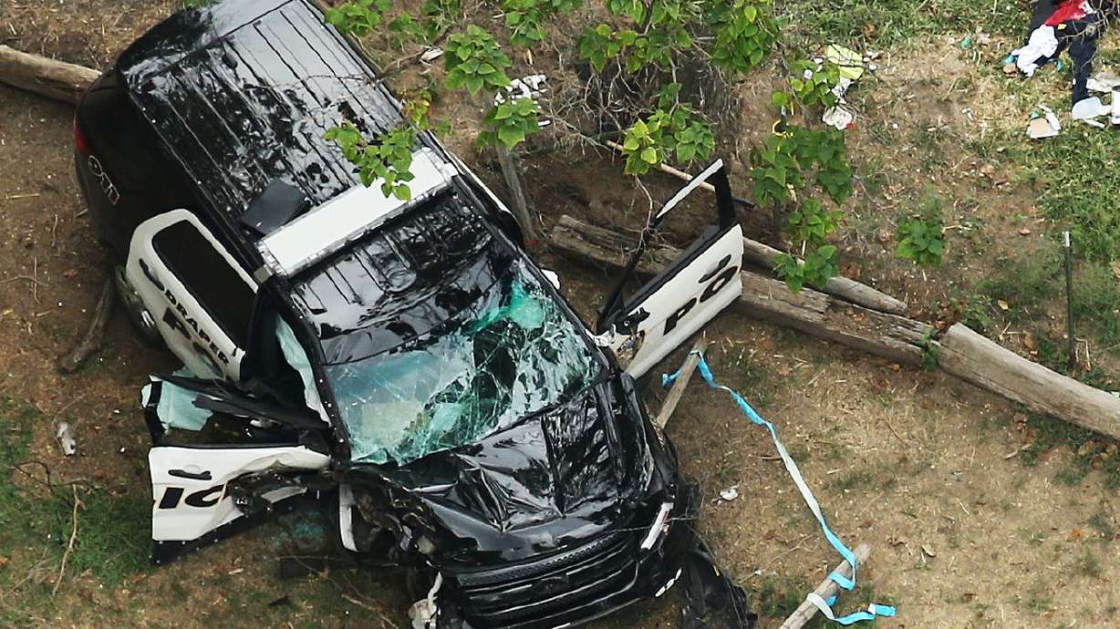 Law enforcement officers investigate the scene after
fatal shots were fired at a Draper Police Sgt. Derek Johnson in
Draper in 2013. Timothy Troy Walker, who was sentenced to life in
prison for killing the officer, is facing another felony charge
after a weapon was allegedly found in his cell.