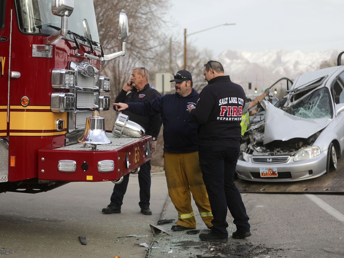 Salt Lake City firefighters work at the scene of an
accident where a car hit a fire truck outside of Salt Lake City
Fire Station 6 in Salt Lake City on Monday, March 8, 2021. Two
firefighters sustained minor injuries.