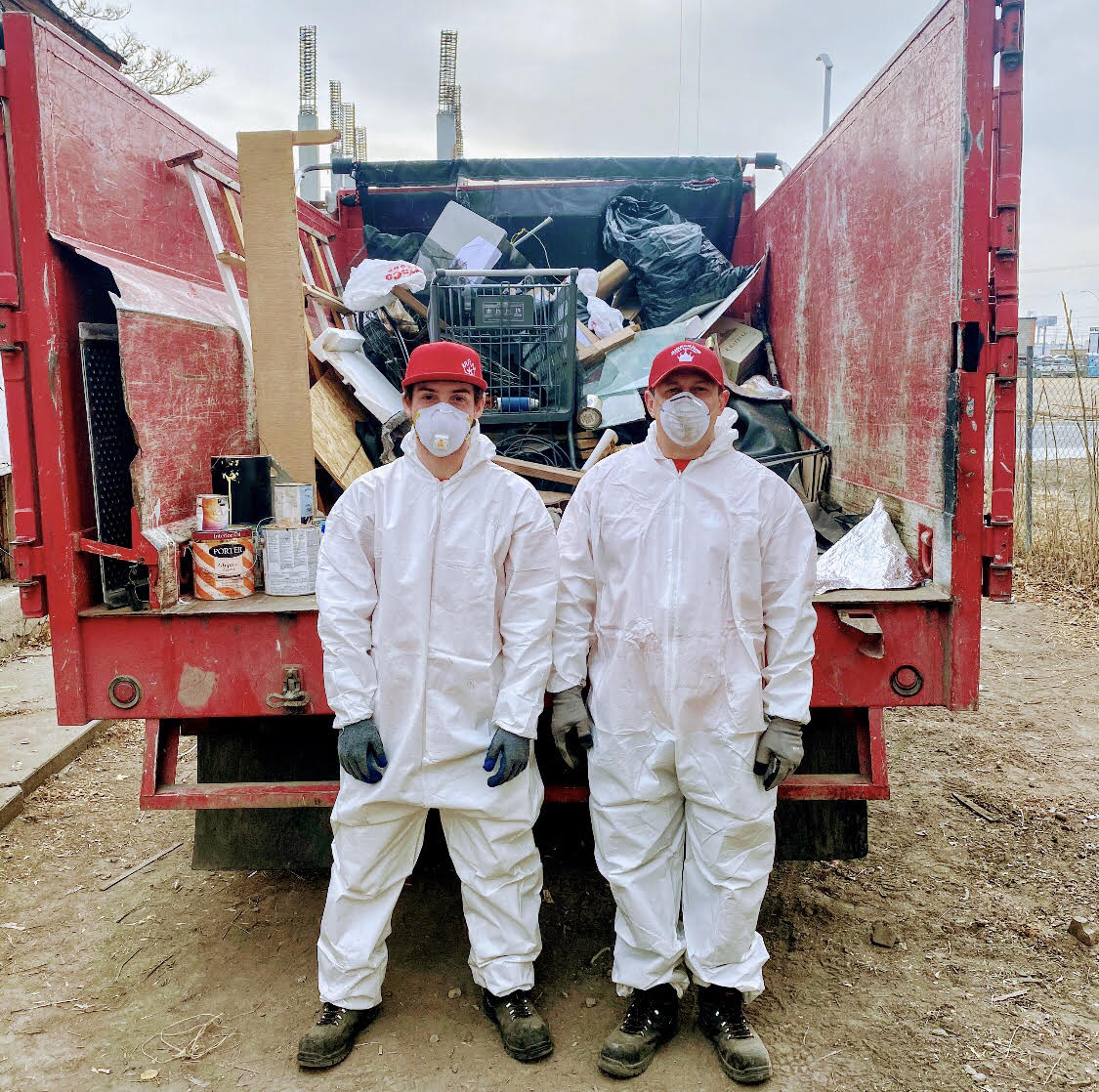 Luke Wren (right) stands with one of his employees after removing items from a local home.