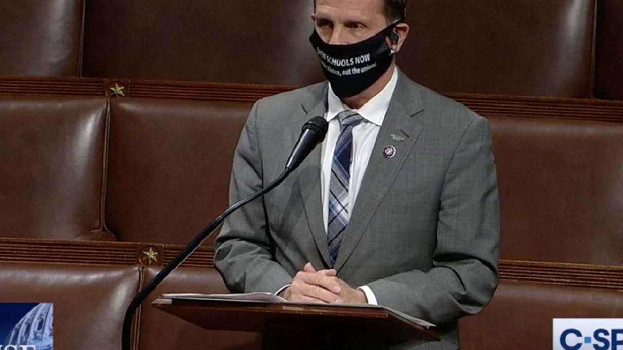 Rep. Chris Stewart, R-Utah, wears an "OPEN SCHOOLS NOW”
mask while speaking on the floor of the House of Representatives at
the Capitol in Washington on Tuesday, March 9, 2021.