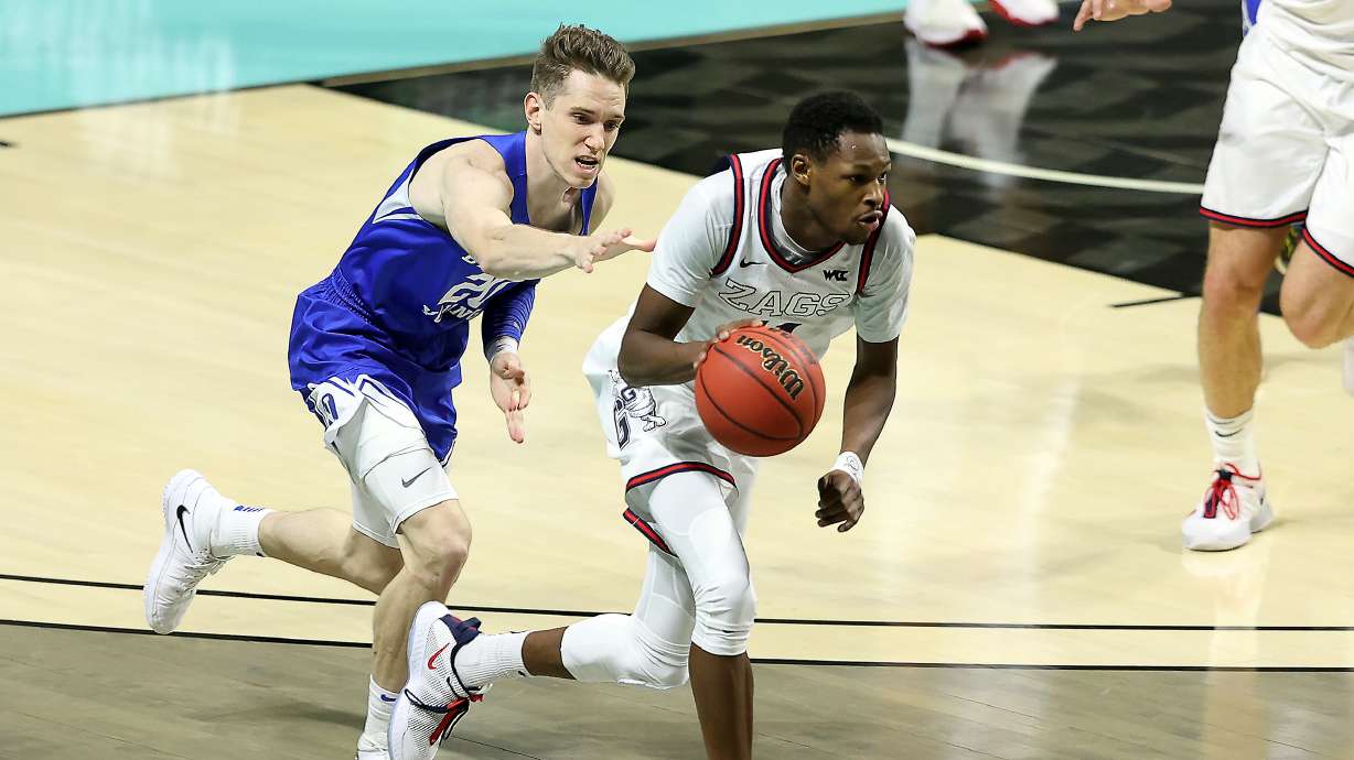Brigham Young Cougars guard Spencer Johnson (20) reaches out to try to foul Gonzaga Bulldogs guard Joel Ayayi (11) as BYU and Gonzaga play in the finals of the West Coast Conference tournament at the Orleans Arena in Las Vegas on Tuesday, March 9, 2021. Gonzaga won 88-78.