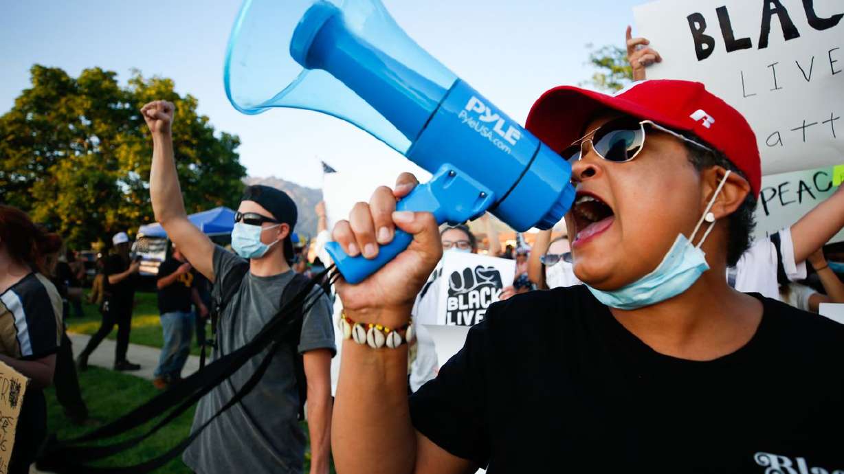 A protester speaks during a protest against police
brutality at the Cottonwood Heights Police Department in Cottonwood
Heights on Monday, Aug. 3, 2020.