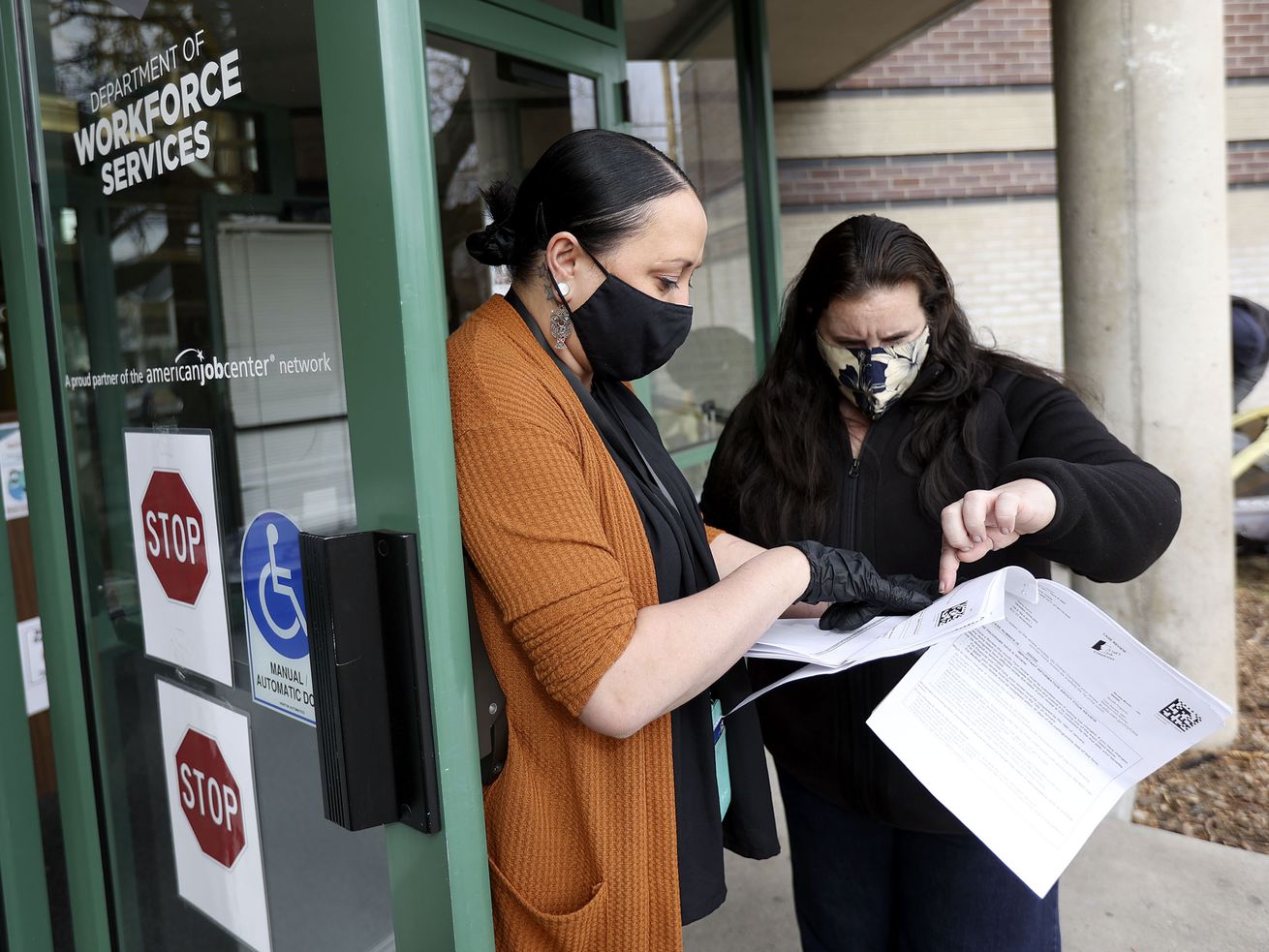 Ashley Woolsey, Department of Workforce Services
employment counselor, chats with Deanna Aguilera, who is
unemployed, about her food stamps application at the Department of
Workforce Services office in Salt Lake City on Friday, Jan. 22,
2021. The state unemployment rate dropped to 3.6%.