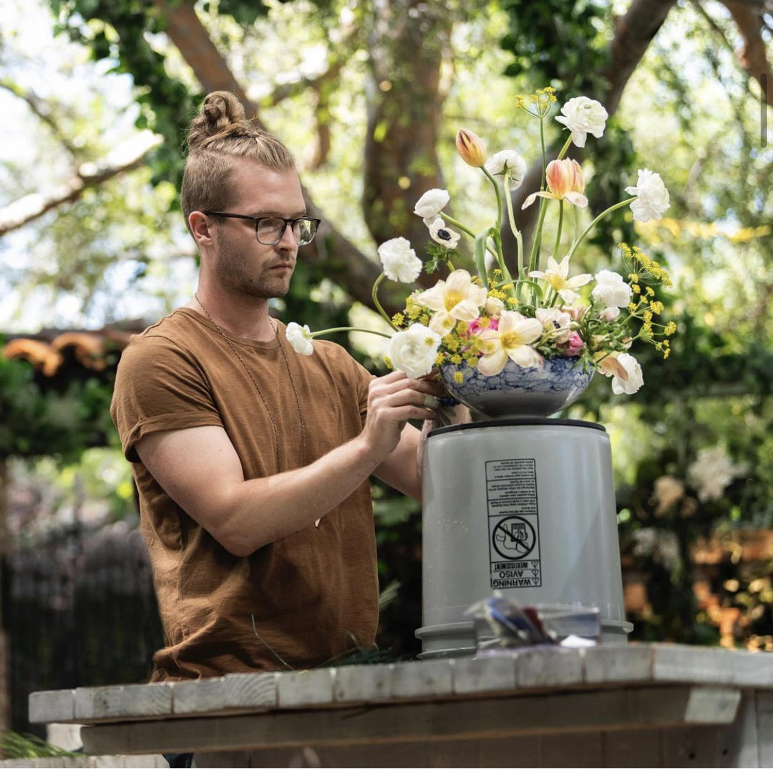 Conner Nesbit creates a floral piece during the third challenge of the HBO series "Full Bloom."