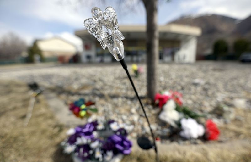 An angel light, flowers and pinwheels are pictured at a
memorial outside of Super Grocery in Ogden on Thursday, March 11,
2021. Satnam Singh, the store’s 65-year-old owner, was fatally shot
while working behind the counter on Feb. 28.