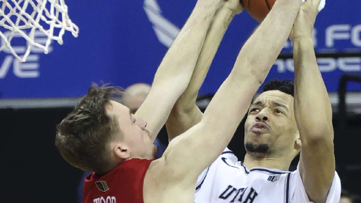 Utah State guard Marco Anthony (44) shoots as UNLV forward Moses Wood (1) defends during the second half of an NCAA college basketball game in the quarterfinals of the Mountain West Conference men's tournament Thursday, March 11, 2021, in Las Vegas. (AP Photo/Isaac Brekken)