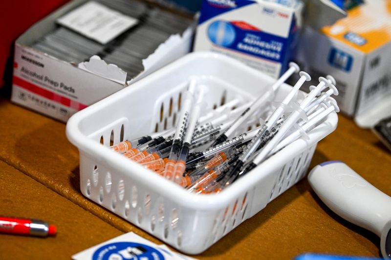 FILE PHOTO:Syringes sit on a table where coronavirus disease vaccines are being administered during a two-day COVID-19 vaccination clinic inside the JBS Greeley Beef plant in Greeley, Colorado, U.S., March 5, 2021.   Alex McIntyre/The Greeley Tribune/Pool