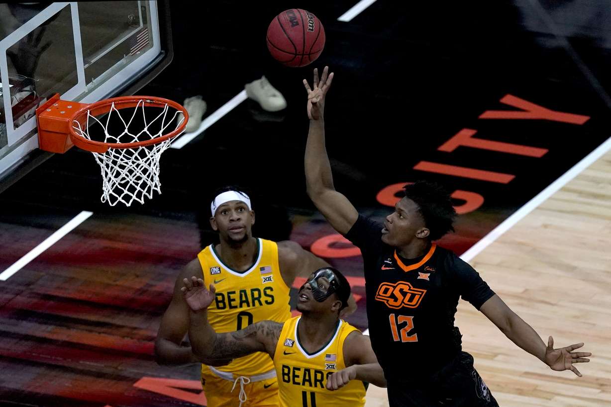 Oklahoma State's Matthew-Alexander Moncrieffe (12) shoots over Baylor's Mark Vital (11) and Flo Thamba (0) during the first half of an NCAA college basketball game in the semifinals of the Big 12 tournament in Kansas City, Mo., Friday, March 12, 2021.