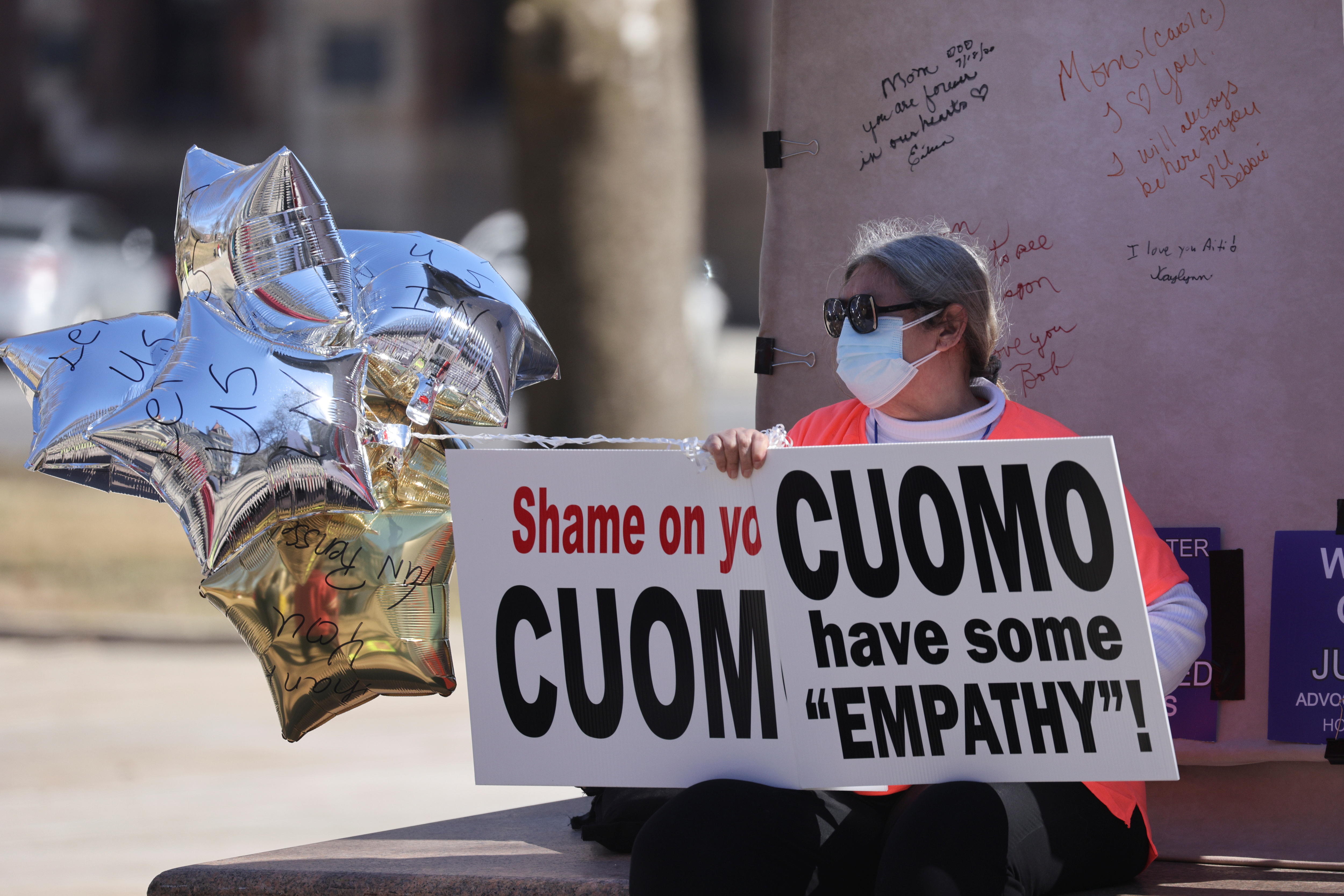 A protestor sits outside the New York State Capitol, following allegations that New York Governor Andrew Cuomo had sexually harassed young women, in Albany, New York, U.S., March 12, 2021.