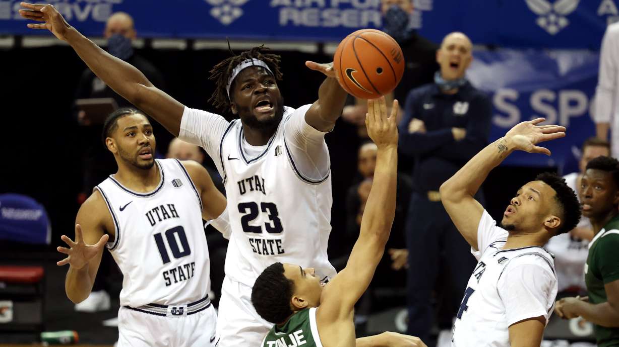 Utah State Aggies center Neemias Queta (23) works to defend Colorado State Rams guard John Tonje (1) as Utah State and Colorado State play in the Mountain West Tournament at the Thomas & Mack Center in Las Vegas on Friday, March 12, 2021.