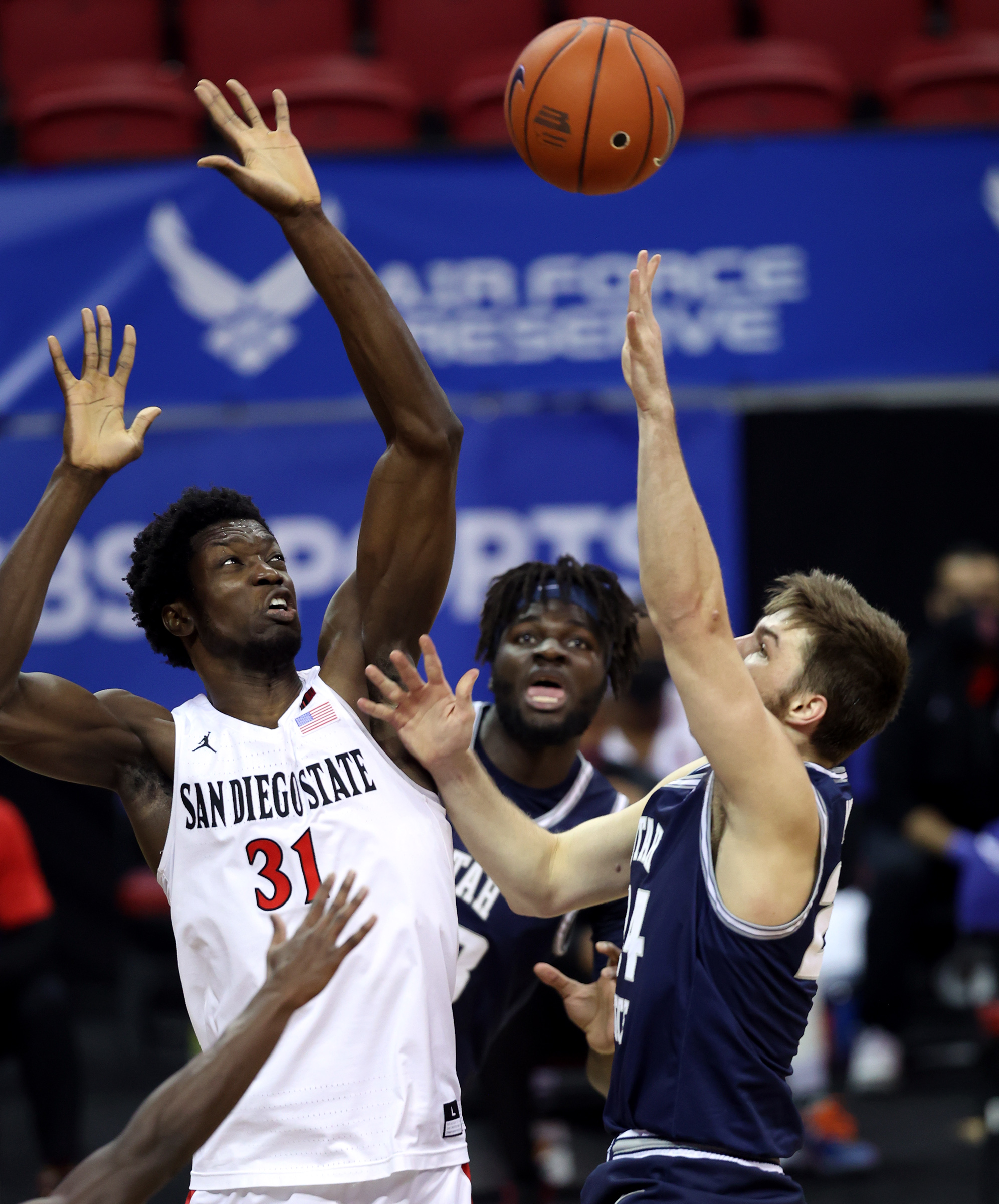 San Diego State Aztecs forward Nathan Mensah (31) blocks a shot by Utah State Aggies guard Rollie Worster (24) as Utah State and San Diego State play in the championship game of the Mountain West Tournament at the Thomas & Mack Center in Las Vegas on Saturday, March 13, 2021.