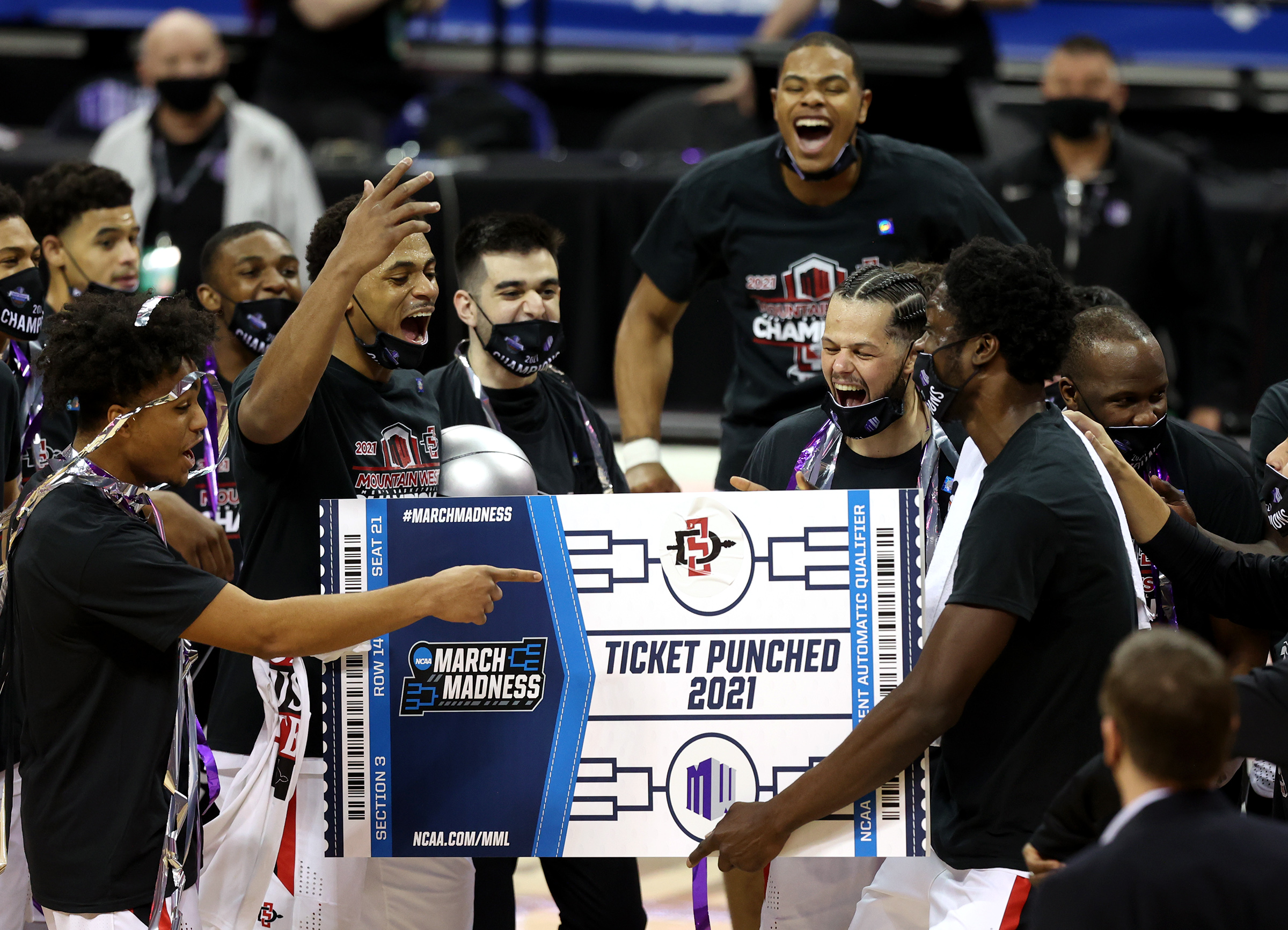 San Diego State celebrate after defeating Utah State 68-57 to claim the Mountain West Tournament Championship at the Thomas & Mack Center in Las Vegas on Saturday, March 13, 2021.