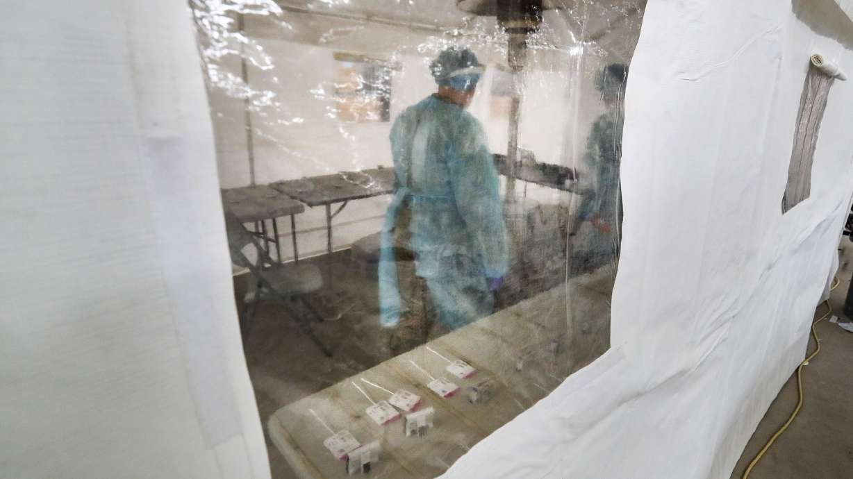 Utah National Guard soldiers time rapid tests as they wait for results at the COVID-19 test facility at the Utah State Fairpark in Salt Lake City on Monday, March 8, 2021.