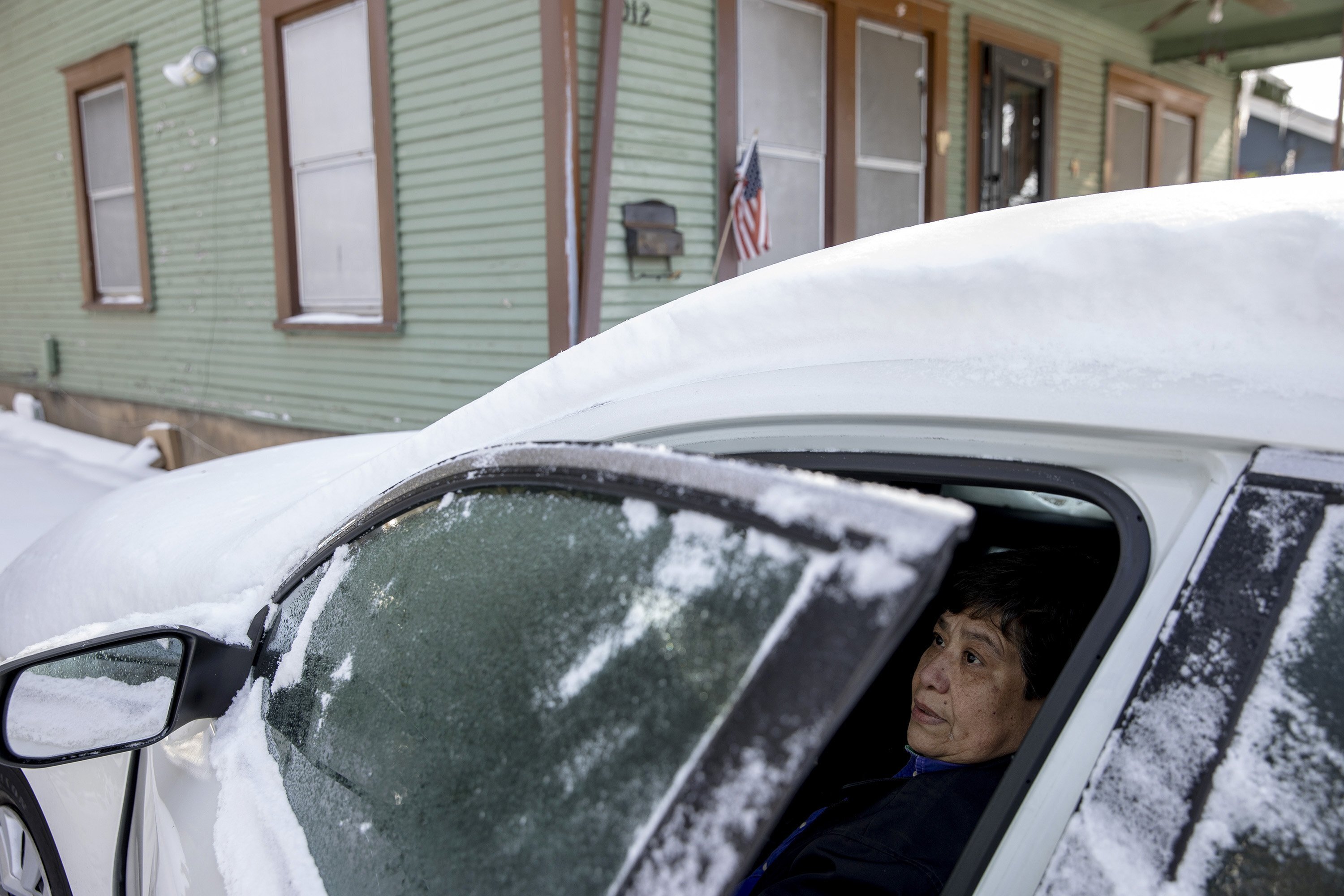 Maria Pineda warms up in her car outside her home on Garden Street in East Austin, Texas, on Tuesday Feb. 16, 2021, during a power outage caused by a winter storm.