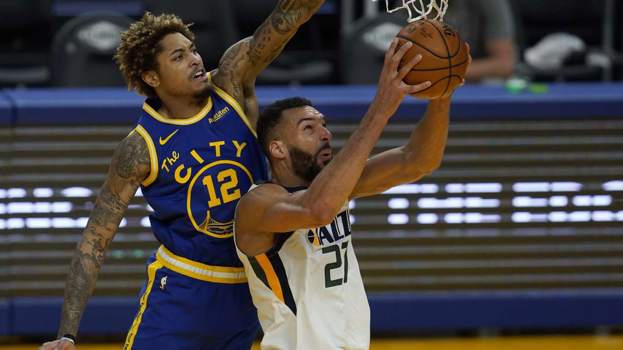 Utah Jazz center Rudy Gobert, right, shoots against Golden State Warriors guard Kelly Oubre Jr., left, during the second half of an NBA basketball game in San Francisco, Sunday, March 14, 2021. (AP Photo/Jeff Chiu)