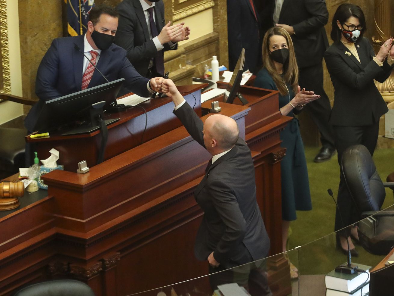 House Speaker Brad Wilson, R-Kaysville, left,
fist-bumps Gov. Spencer Cox after the governor addressed lawmakers
at the end of the 2021 legislative session in the House chamber at
the Capitol in Salt Lake City on Friday, March 5, 2021.