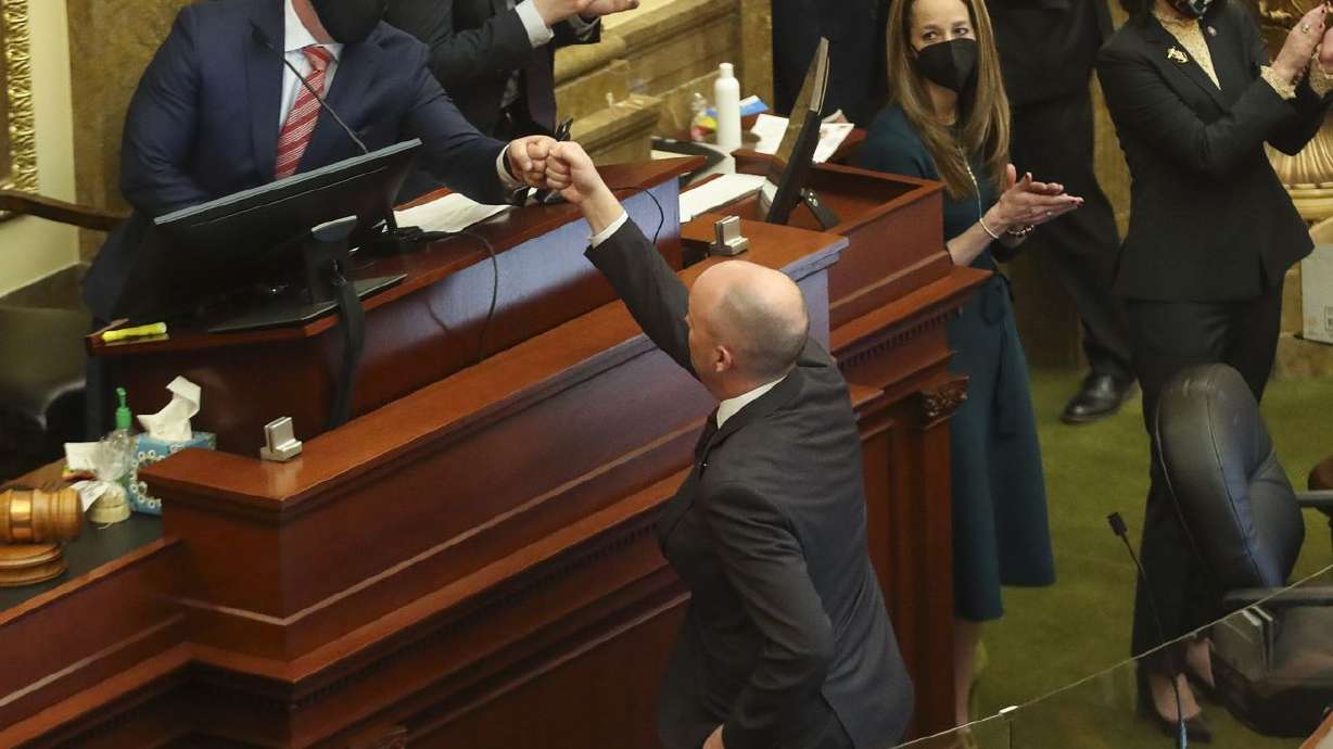 House Speaker Brad Wilson, R-Kaysville, left,
fist-bumps Gov. Spencer Cox after the governor addressed lawmakers
at the end of the 2021 legislative session in the House chamber at
the Capitol in Salt Lake City on Friday, March 5, 2021.