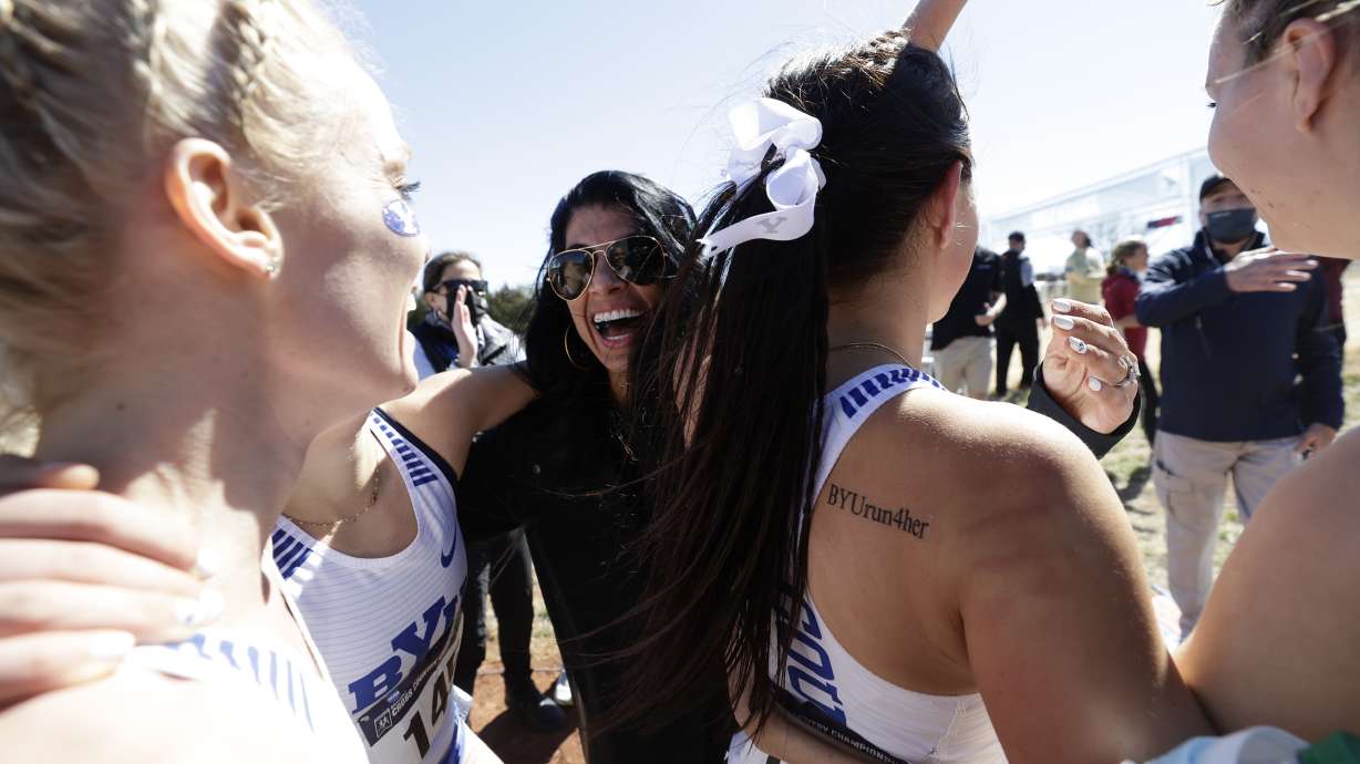 BYU women's cross country coach Diljeet Taylor celebrates the program's first national title since 2002, Monday, March 15, 2021 in Stillwater, Oklahoma.