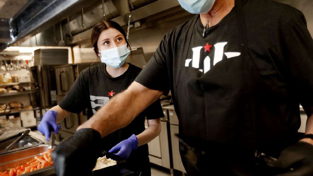 Maddie Evans, left, and Guy Saucer, of BD Catering in
Syracuse, prepare meals for domestic violence victims on Friday,
March 12, 2021.