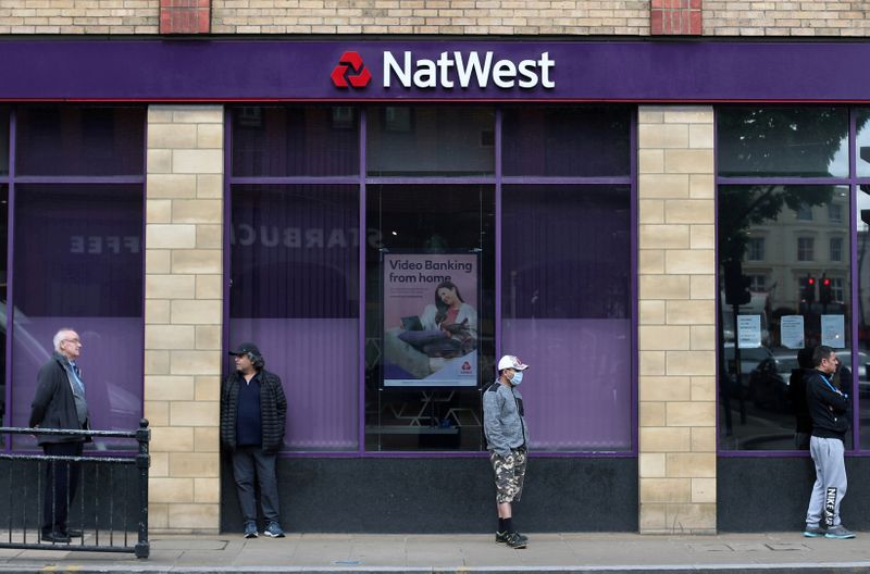 FILE PHOTO: People maintain social distance while they queue outside a Natwest bank in Wimbledon in London, Britain, May 1, 2020. REUTERS/Hannah McKay