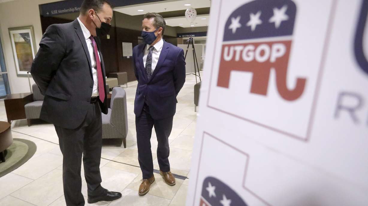 Sen. Mike Lee, R-Utah, left, talks to Derek Brown, Utah Republican Party chairman, at a Republican election night event at the Utah Association of Realtors building in Sandy on Tuesday, Nov. 3, 2020.