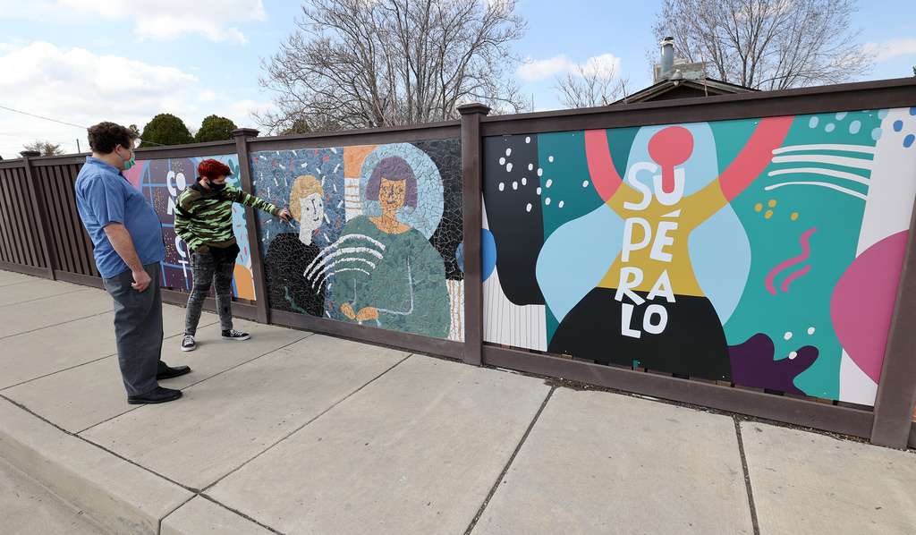 Artist Roger Whiting, of Community Arts of Utah, left, and project assistant Mati Simonds inspect their mosaic mural on 2700 West between 3500 South and 3100 South in West Valley City on Tuesday, March 16, 2021.